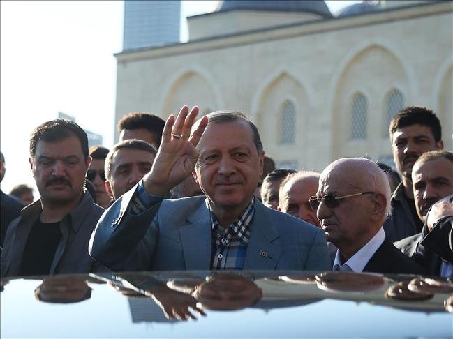 Turkish President Recep Tayyip Erdogan (C) greets people after performing Eid al-Fitr prayer at Mimar Sinan Masjid Istanbul on June 25, 27.