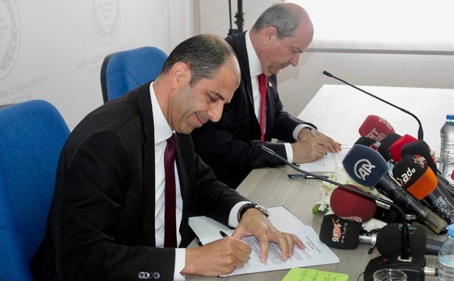 UBP leader and PM-designate Ersin Tatar on right and HP leader Kudret Özersay sign the coalition protocol at the TRNC Parliament in Nicosia, on 22 May 2019