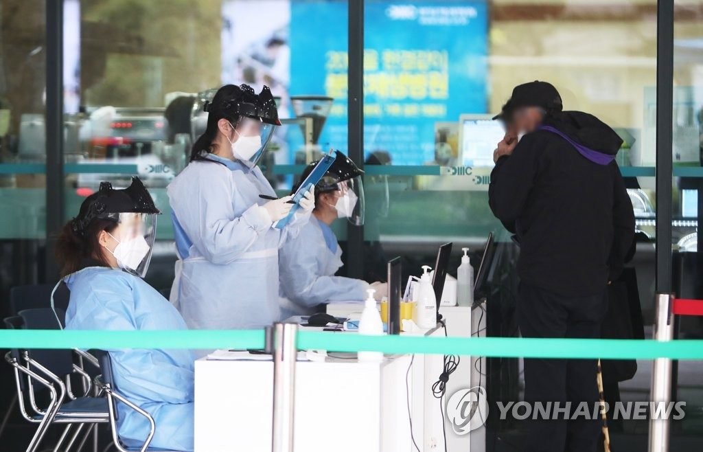Medical workers check a visitor at Bundang Jesaeng Hospital in Seongnam, south of Seoul, on April 17, 2020 Pic Yonhap